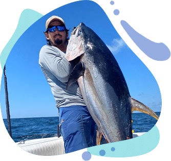 Captain Alex holding large yellowfin tuna on Go Long Chapter fishing trip