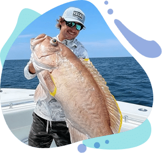 Captain Stephen holding large red snapper on Go Long Chapter fishing trip